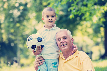 Image showing grandfather and child have fun  in park