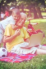 Image showing grandfather and child using laptop