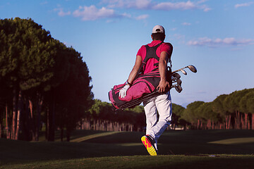 Image showing golfer  walking and carrying golf  bag