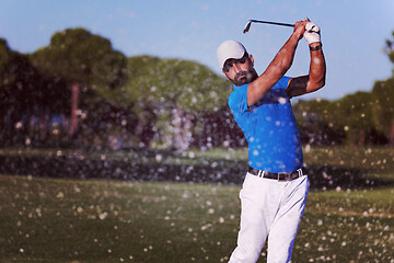 Image showing pro golfer hitting a sand bunker shot