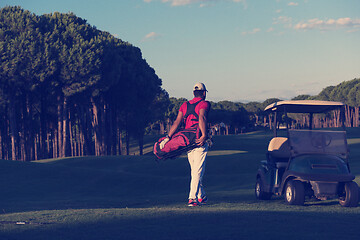 Image showing golfer  walking and carrying golf  bag