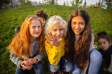 Image showing Interracial group of kids, girls and boys playing together at the park in summer day