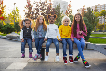 Image showing Interracial group of kids, girls and boys playing together at the park in summer day