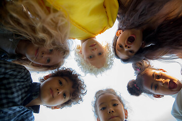 Image showing Interracial group of kids, girls and boys playing together at the park in summer day