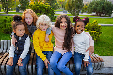 Image showing Interracial group of kids, girls and boys playing together at the park in summer day