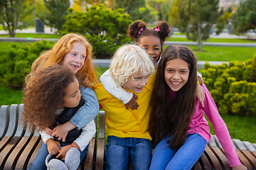 Image showing Interracial group of kids, girls and boys playing together at the park in summer day