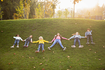 Image showing Interracial group of kids, girls and boys playing together at the park in summer day