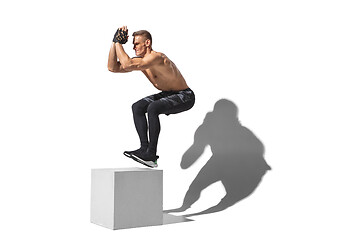 Image showing Beautiful young male athlete practicing on white studio background with shadows