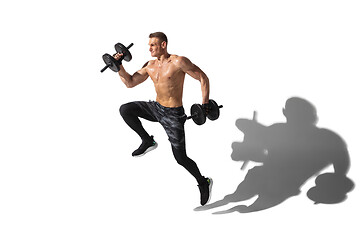 Image showing Beautiful young male athlete practicing on white studio background with shadows