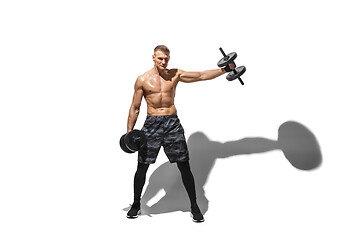 Image showing Beautiful young male athlete practicing on white studio background with shadows