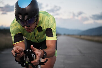 Image showing triathlon athlete riding a bike