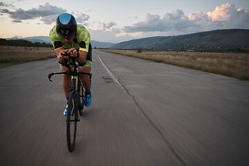 Image showing triathlon athlete riding a bike