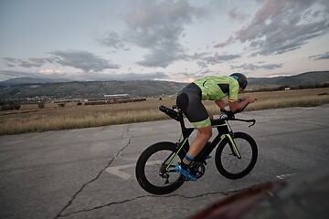 Image showing triathlon athlete riding a bike