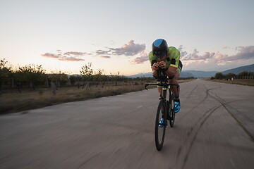 Image showing triathlon athlete riding a bike