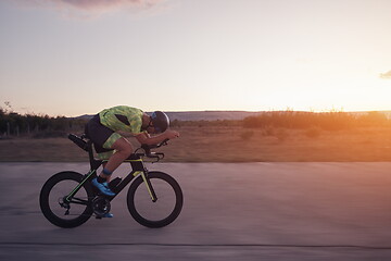 Image showing triathlon athlete riding a bike