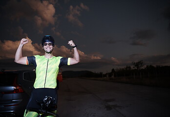 Image showing triathlon athlete portrait while resting on bike training