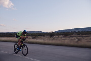 Image showing triathlon athlete riding a bike