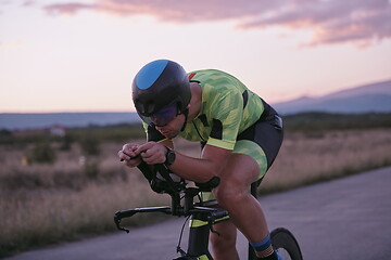 Image showing triathlon athlete riding a bike