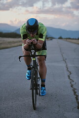 Image showing triathlon athlete riding a bike