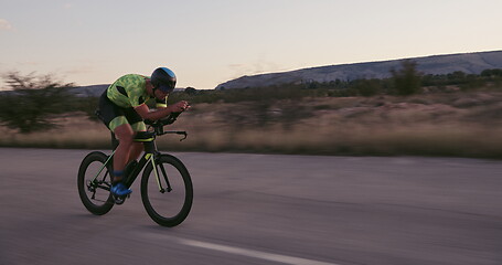 Image showing triathlon athlete riding a bike