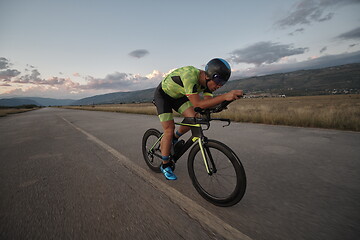 Image showing triathlon athlete riding a bike