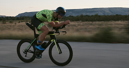 Image showing triathlon athlete riding a bike