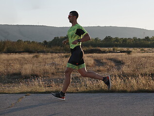 Image showing triathlon athlete running on morning trainig