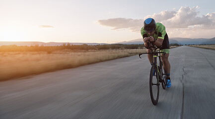 Image showing triathlon athlete riding a bike