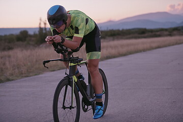 Image showing triathlon athlete riding a bike