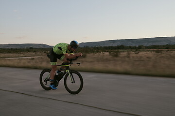 Image showing triathlon athlete riding a bike