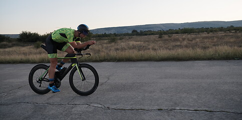 Image showing triathlon athlete riding a bike