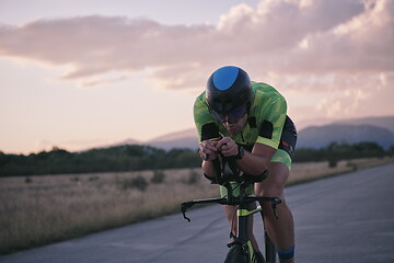 Image showing triathlon athlete riding a bike