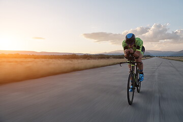 Image showing triathlon athlete riding a bike