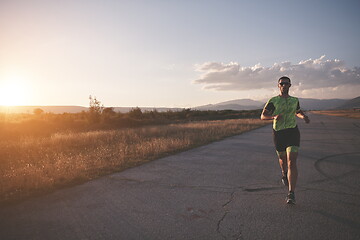 Image showing triathlon athlete running on morning trainig