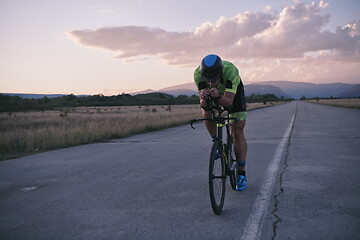 Image showing triathlon athlete riding a bike