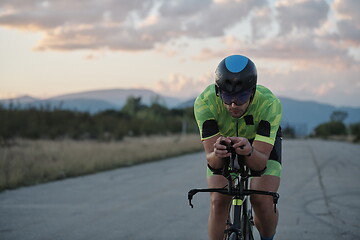 Image showing triathlon athlete riding a bike