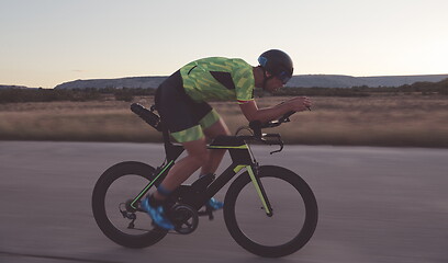 Image showing triathlon athlete riding a bike