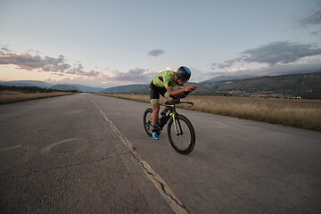 Image showing triathlon athlete riding a bike