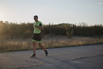 Image showing triathlon athlete running on morning trainig