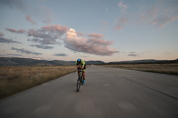 Image showing triathlon athlete riding a bike