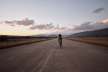 Image showing triathlon athlete riding a bike