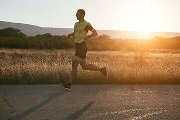 Image showing triathlon athlete running on morning trainig