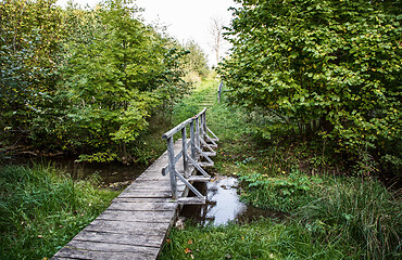 Image showing wooden footbridge across the river