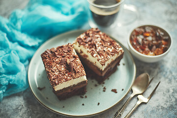 Image showing Close up on chocolate pieces of layered cake. Sprinkled with milk chocolate