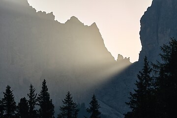 Image showing Sunrise between mountain cliffs