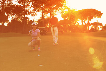 Image showing couple on golf course at sunset