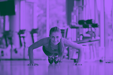 Image showing warming up and doing some push ups a the gym