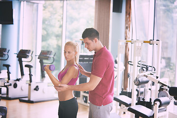 Image showing young sporty woman with trainer exercise weights lifting