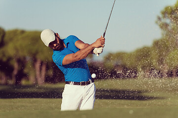 Image showing pro golfer hitting a sand bunker shot