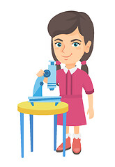 Image showing Little caucasian schoolgirl using a microscope.